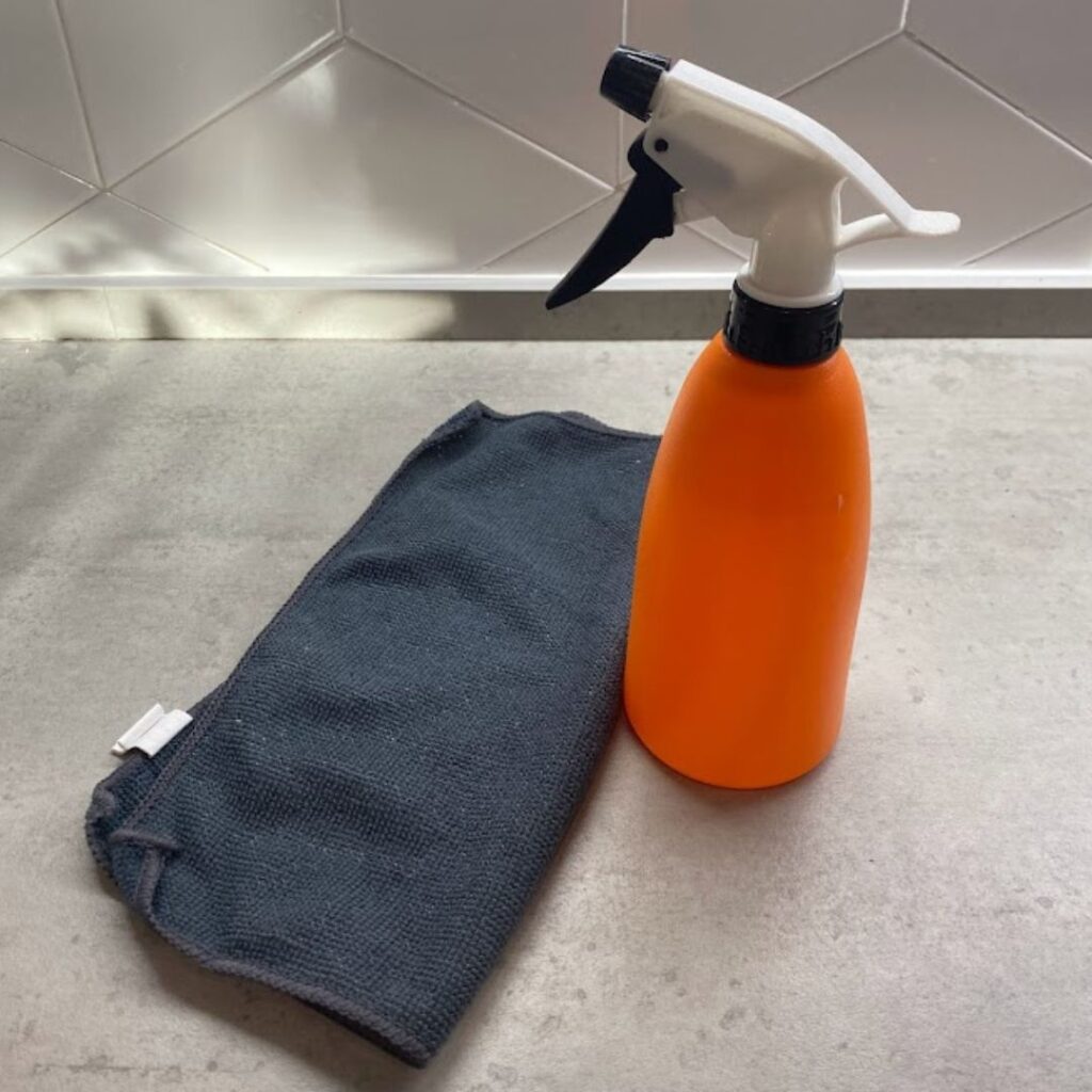 a water spray and cloth for cleaning